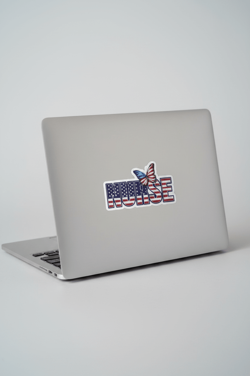 Silver laptop with a sticker on a white surface