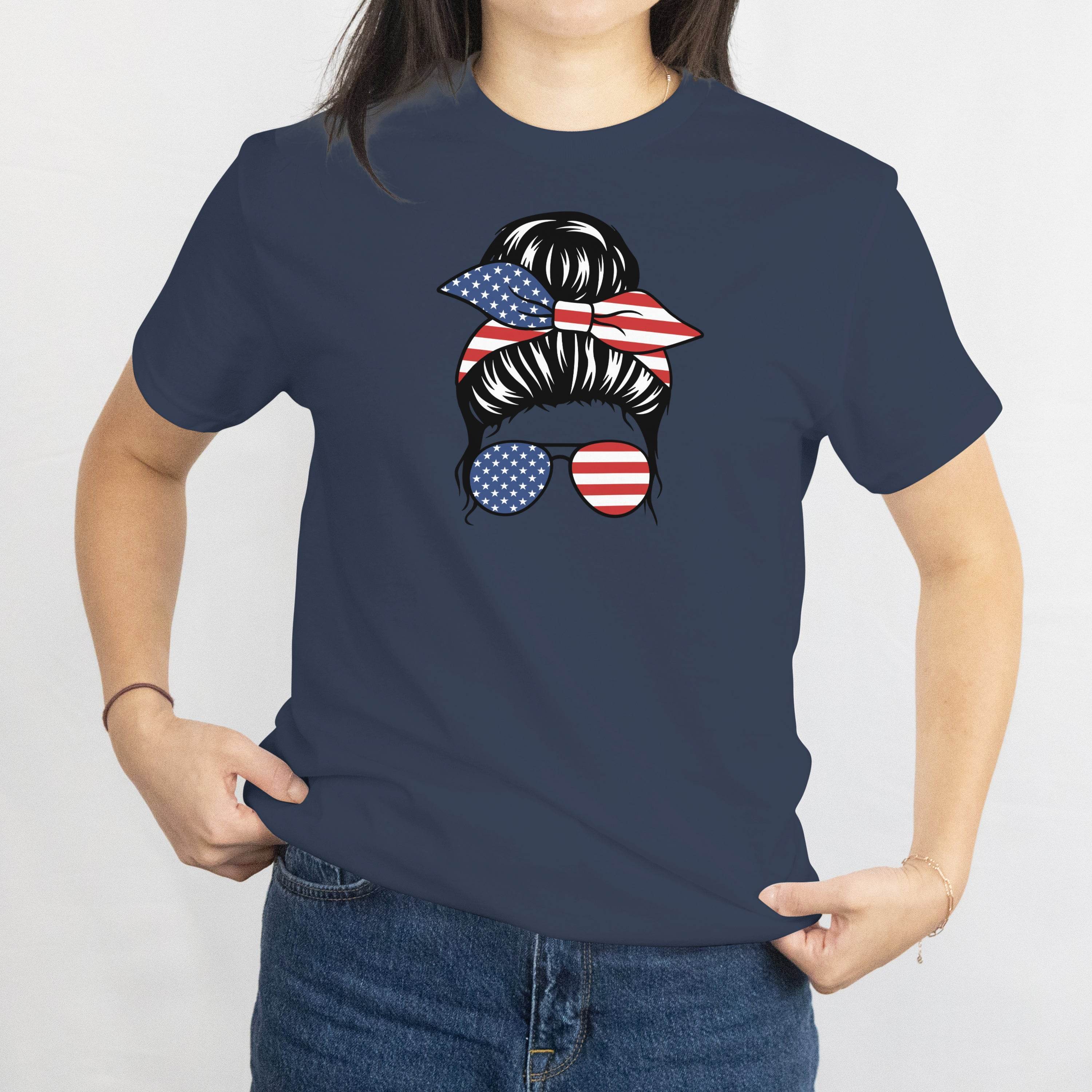 Gildan Patriotic Messy Bun T-Shirt with American flag bandana and star-spangled sunglasses on navy tee