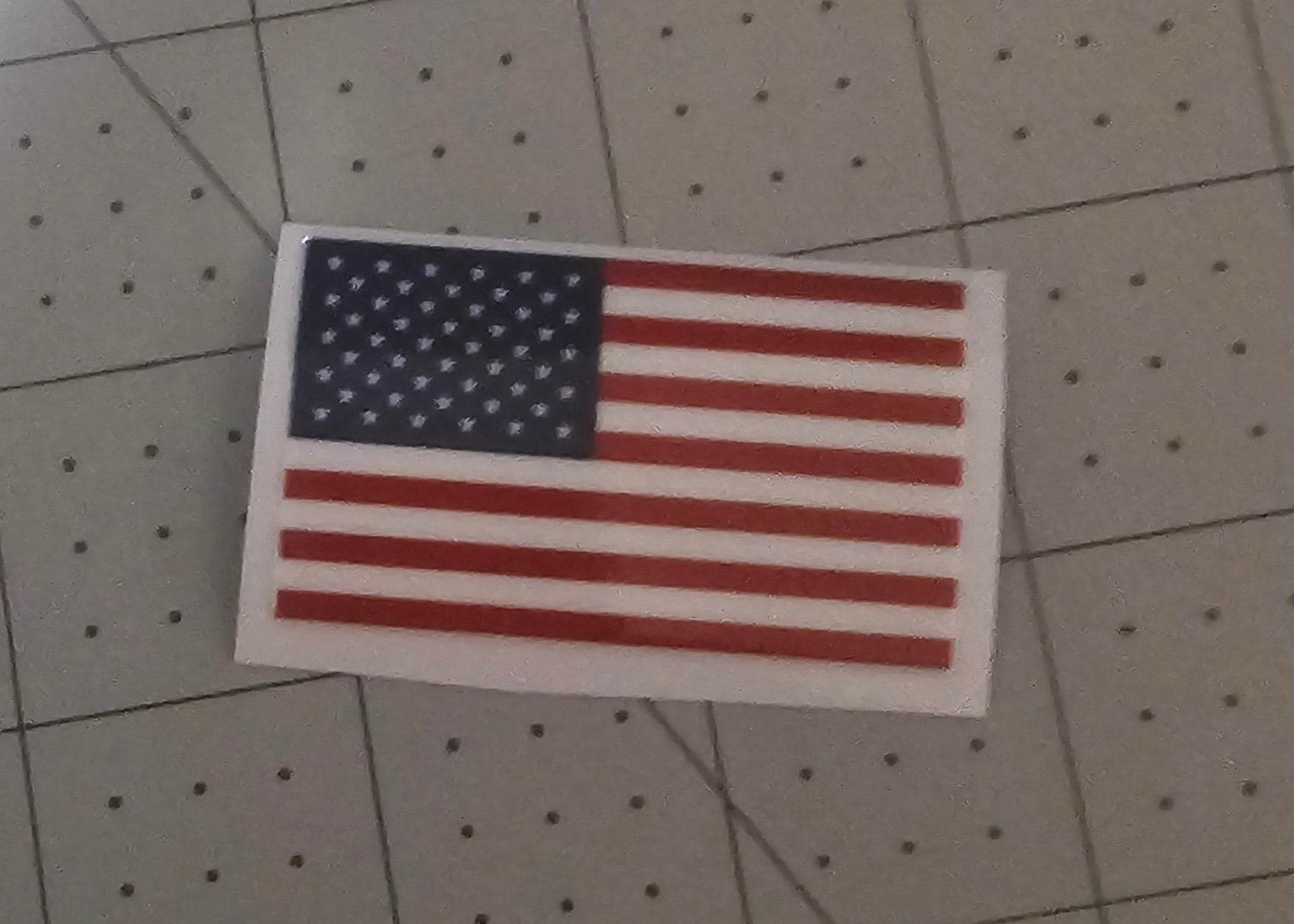 American flag UV DTF decal on white backing, 2x1, durable scratch-resistant and waterproof.