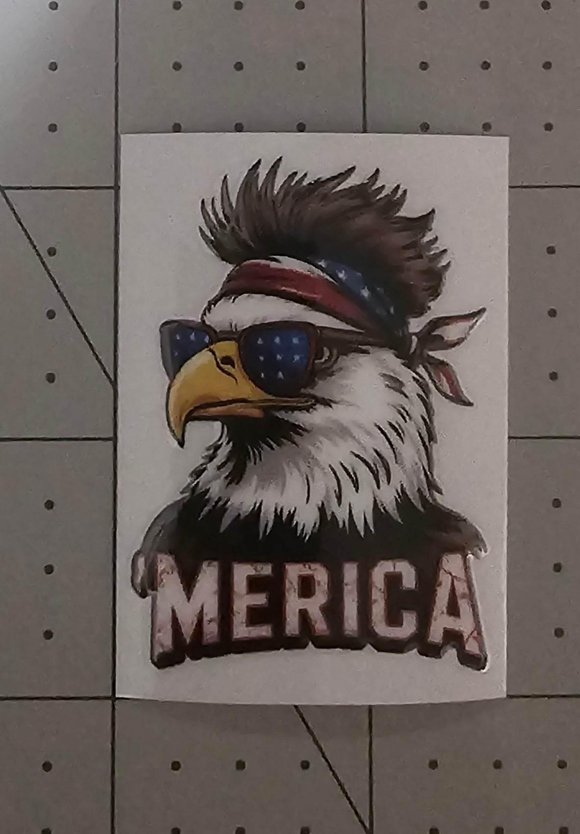 Sticker of an eagle with sunglasses and a bandana, featuring the word 'MERICA', on a white background.