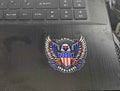 Decorative emblem with an eagle and American flag on a laptop
