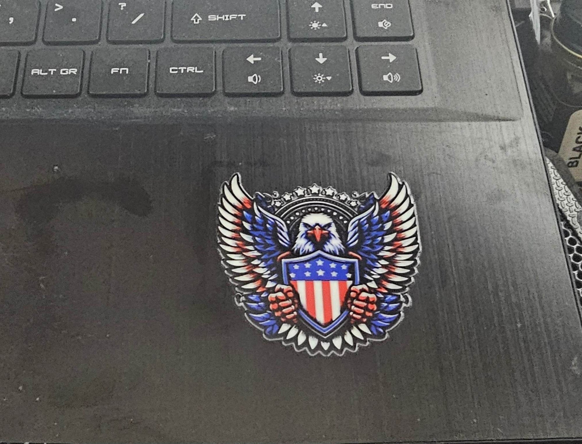 Decorative emblem with an eagle and American flag on a laptop