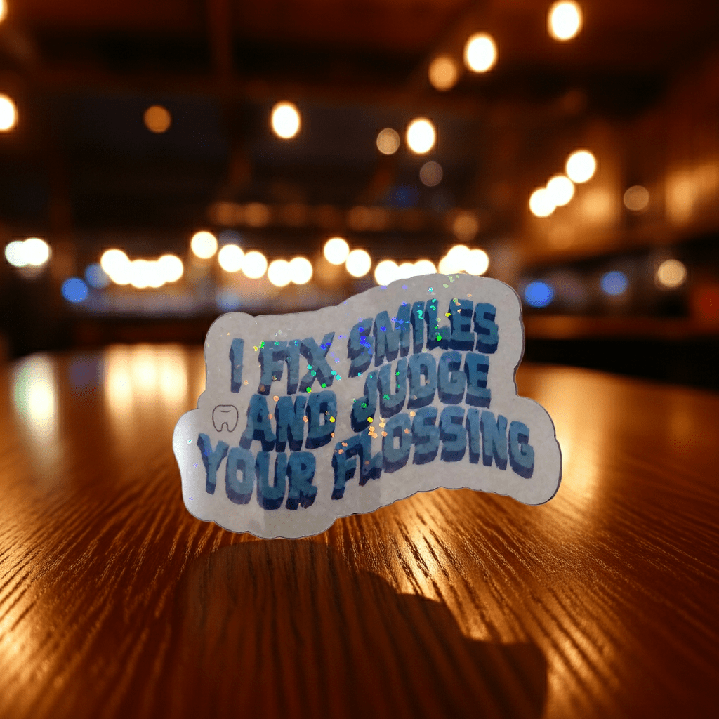 Sticker with text on a wooden surface with blurred lights in the background