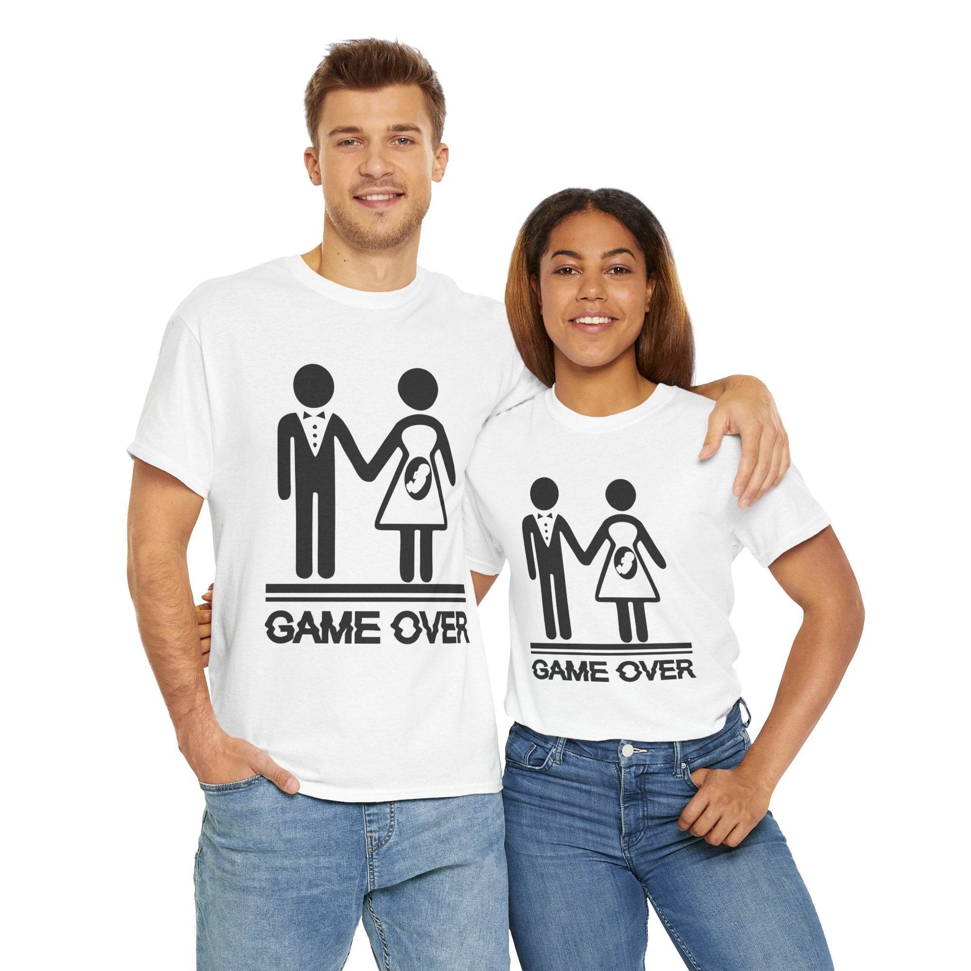 Couple wearing Game Over wedding and pregnancy reveal tees featuring stick-figure family and baby icon.