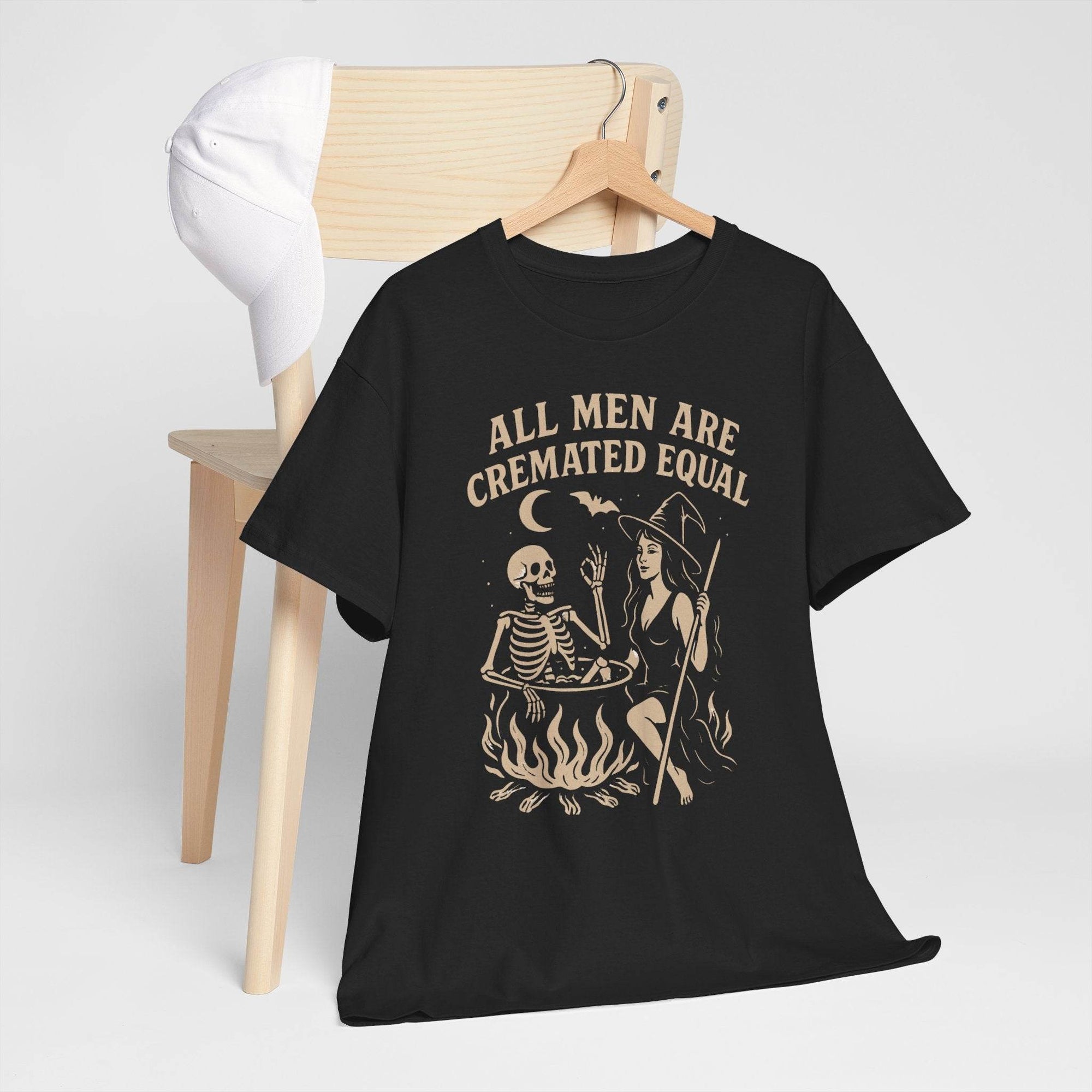 Black Gildan 5000 T-shirt with vintage witch cauldron scene, skeleton, and bold All Men Are Cremated Equal text.