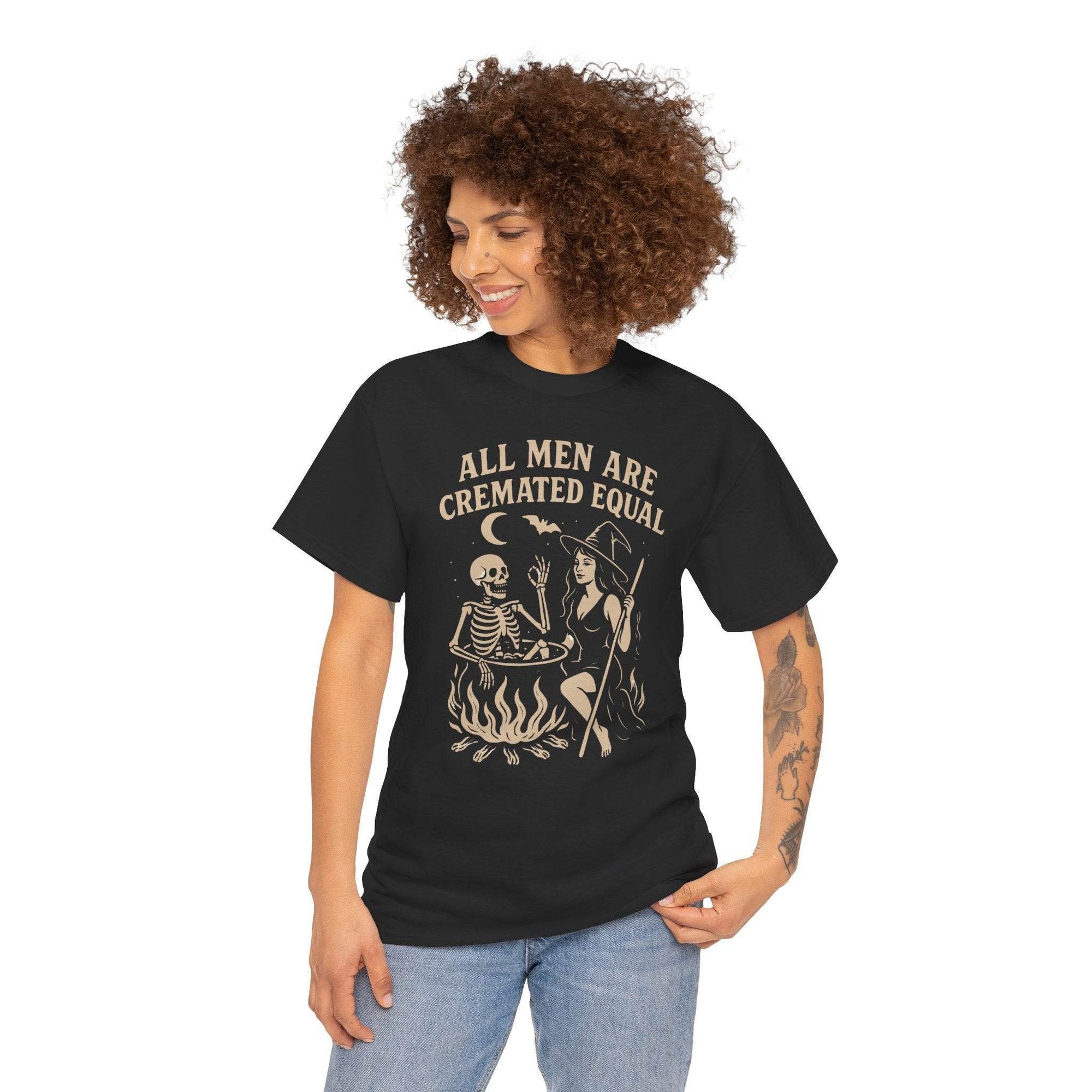 Model wearing All Men Are Cremated Equal Witch Cauldron Funny Halloween T‑Shirt on black Gildan 5000.