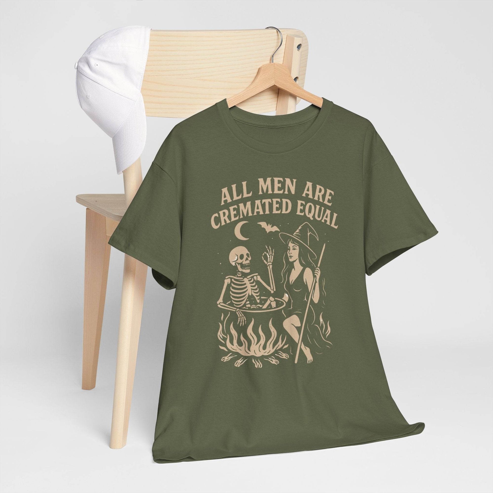 Olive T-shirt featuring All Men Are Cremated Equal with witch, skeleton, and cauldron flames on Gildan 5000 tee.