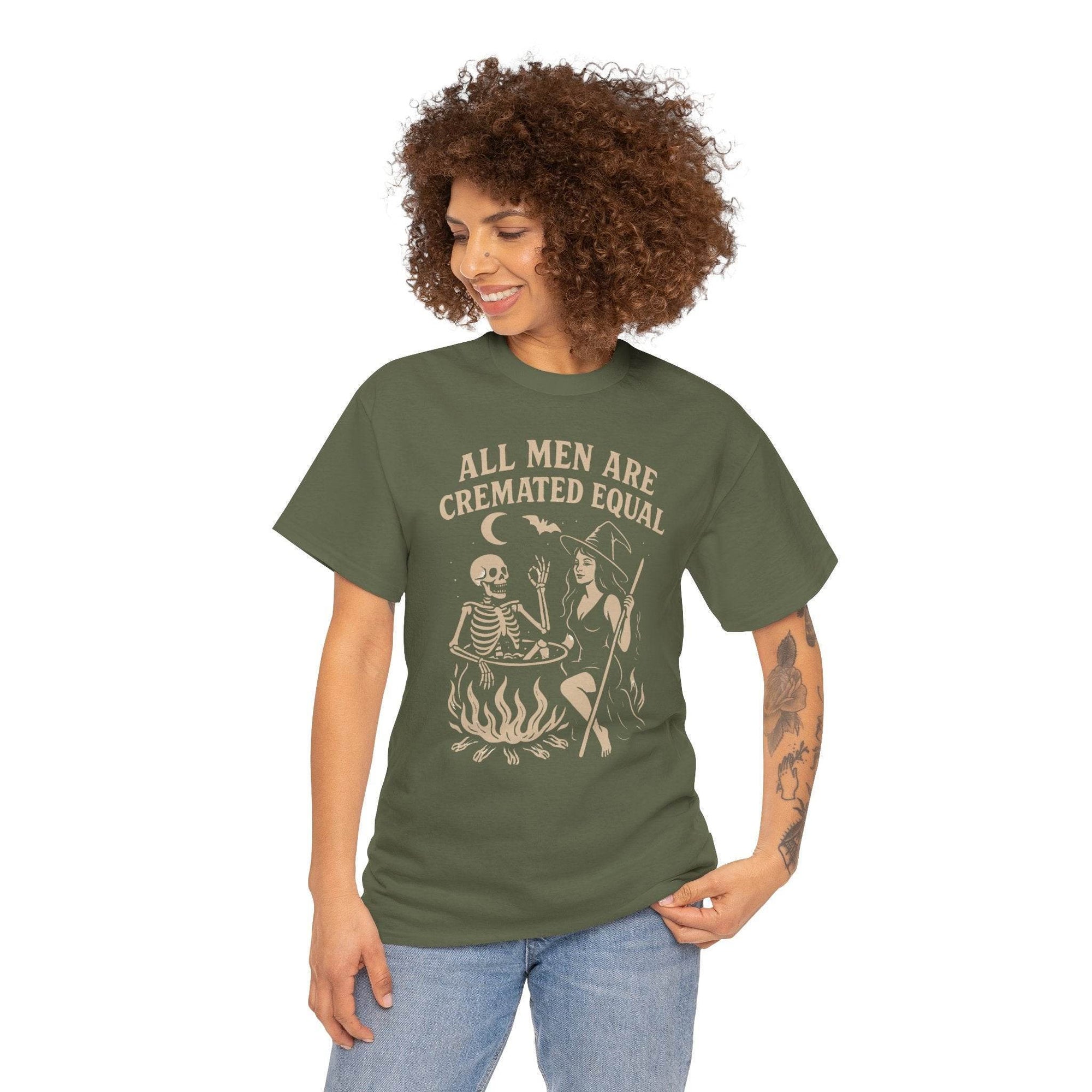 Woman wearing olive green t-shirt with witch cauldron scene and the bold slogan All Men Are Cremated Equal.