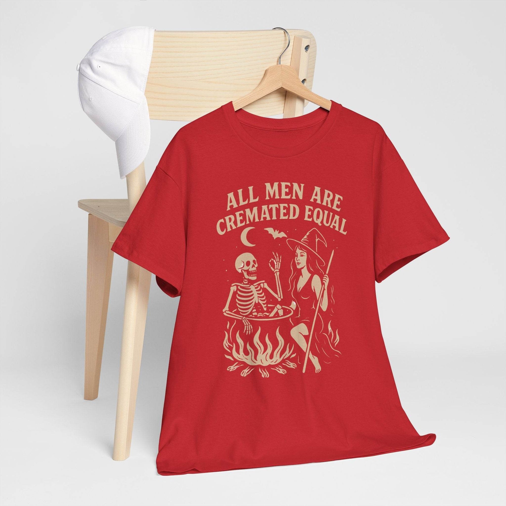 Red Gildan 5000 tee featuring a witch with cauldron and skeleton, flames, and the text All Men Are Cremated Equal.