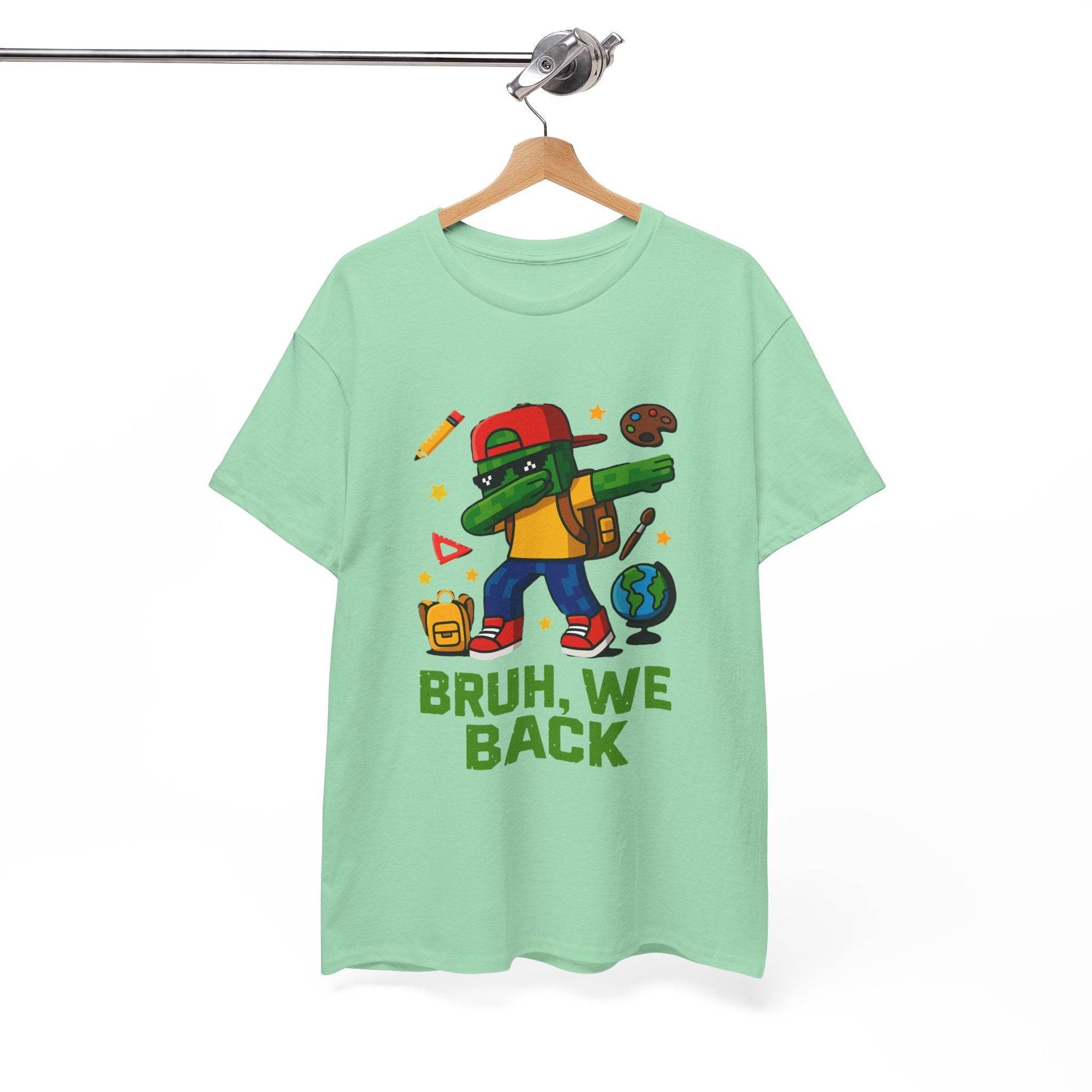 Gamer kid dabbing on a mint green tee with backpack, globe, pencil, and school icons; BRUH, WE BACK.